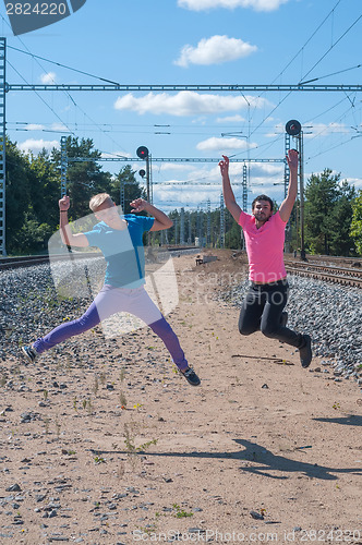 Image of Two handsome young guys jumping