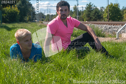 Image of Two handsome young guys on the grass