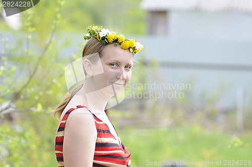 Image of portrait of the happy woman with a wreath on the head.