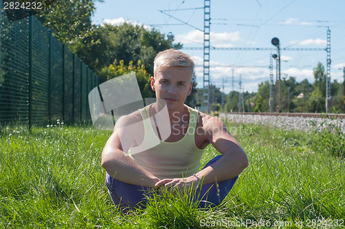 Image of Handsome young man on the grass