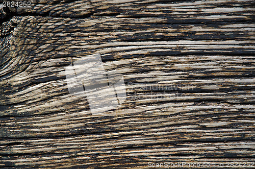 Image of Weathered tarred wooden background