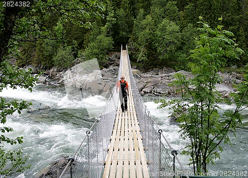 Image of Man on suspension bridge