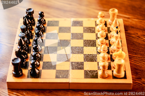 Image of Ancient wooden chess standing on chessboard