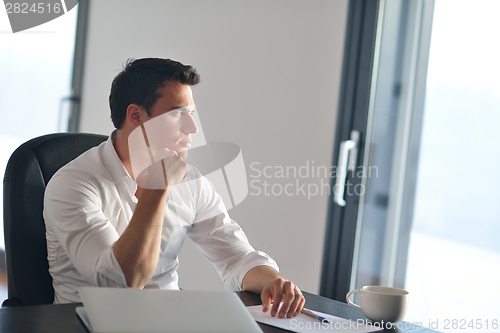 Image of business man working on laptop computer at home