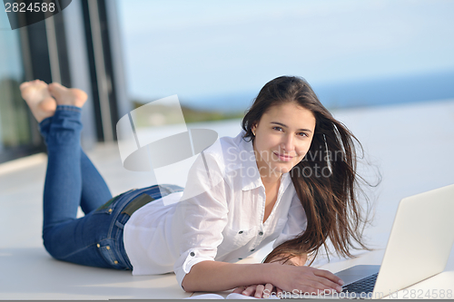 Image of relaxed young woman at home