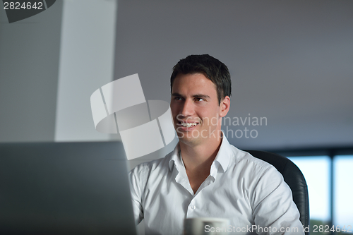Image of business man working on laptop computer at home
