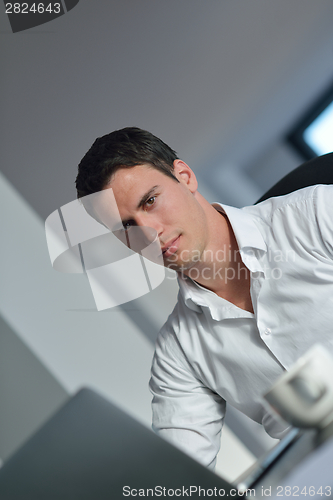 Image of business man working on laptop computer at home