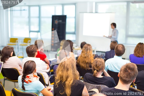 Image of Speaker at Business convention and Presentation.