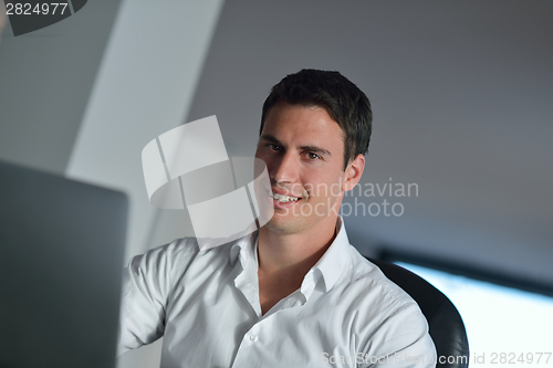 Image of business man working on laptop computer at home