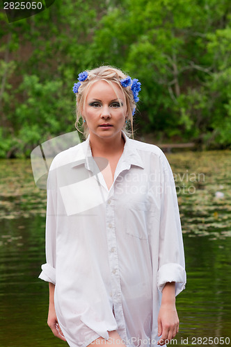 Image of Beautiful woman in white coming out from pond