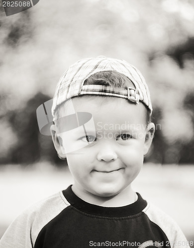 Image of Happy Child Wearing Striped Cap In Outdoor Portrait