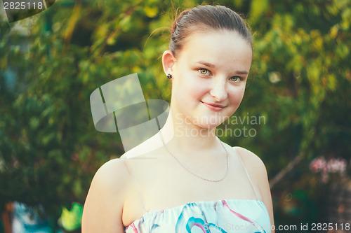 Image of Portrait of face young beautiful girl woman on green outdoor bac