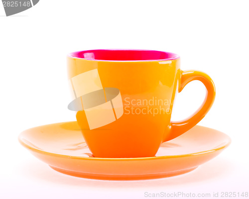 Image of Orange Color Cup On Plate