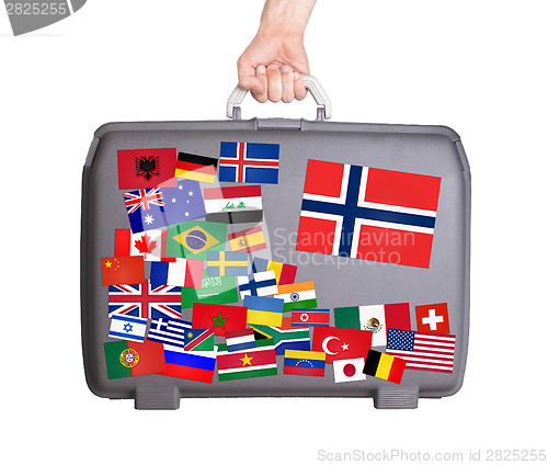 Image of Used plastic suitcase with stickers