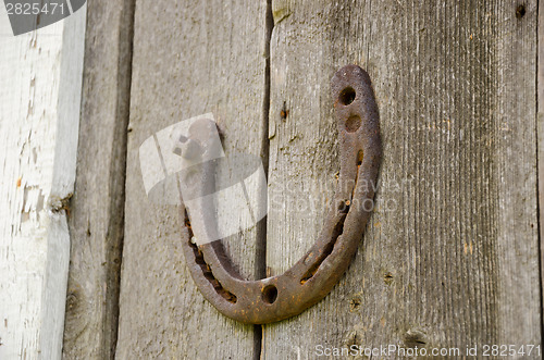 Image of horseshoe symbol happiness on wooden background  