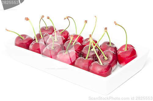 Image of White square dish arranged with big ripe cherry berries