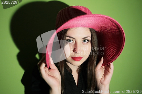 Image of Woman with pink straw hat