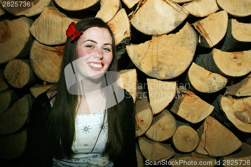 Image of Woman posing with chopped wood