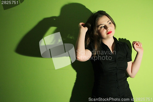 Image of Young woman on green background