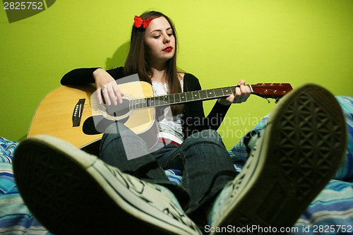 Image of Girl playing guitar
