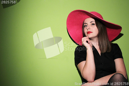 Image of Young woman wearing pink hat