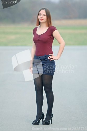 Image of Young woman posing on street