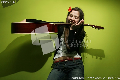 Image of Brunette playing with guitar