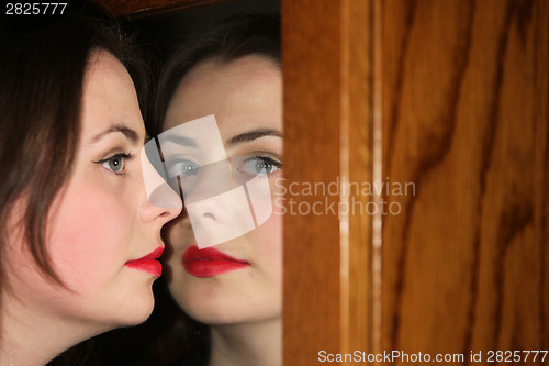 Image of Woman posing with mirror refection