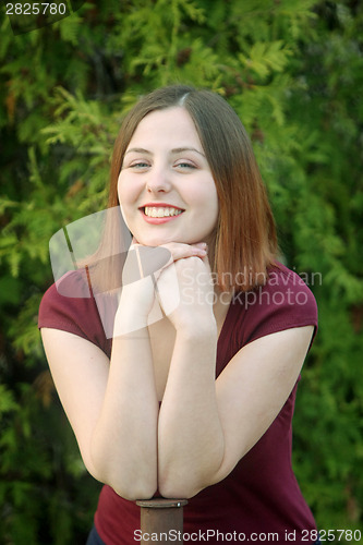 Image of Young woman posing outside