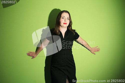 Image of Woman posing against green background