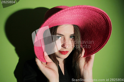 Image of Charming girl with pink straw hat