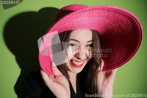 Image of Girl with pink hat laughing