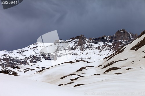 Image of Snowy mountains and storm clouds