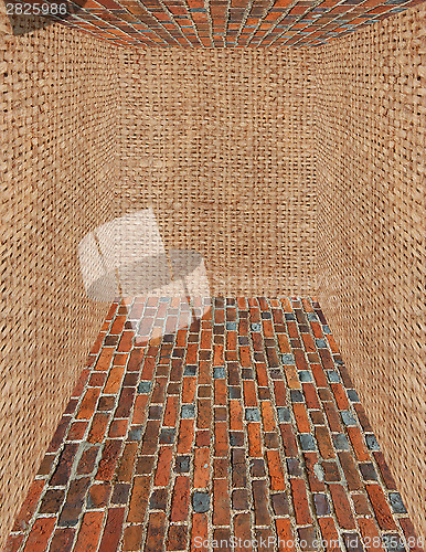 Image of room made from brick and sack walls