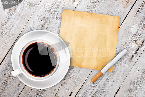Image of Cup of coffee with cigarette 