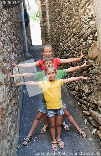 Image of Funny children on narrow street