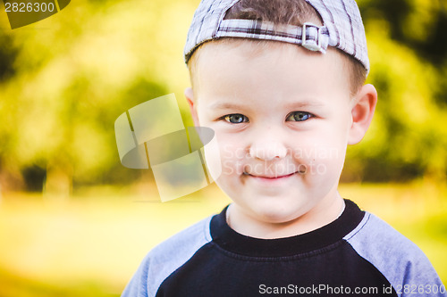 Image of Happy Child Wearing Striped Cap In Outdoor Portrait