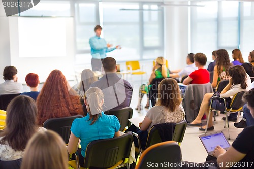 Image of Speaker at Business convention and Presentation.