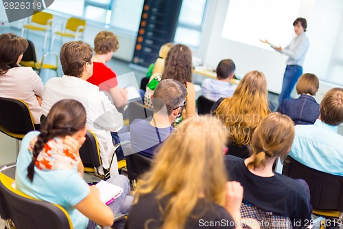 Image of Speaker at Business convention and Presentation.