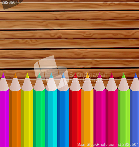 Image of Palette pencils on wooden background