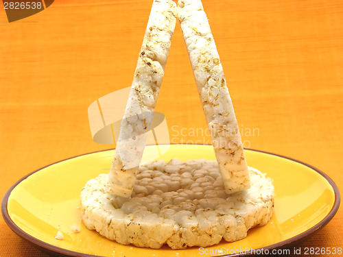 Image of Slices of puffed rice arranged on a bowl of ceramik on white