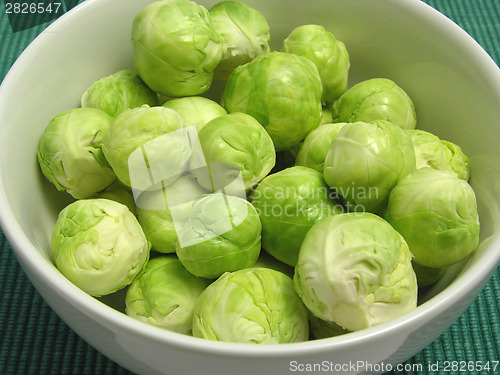 Image of Brussels sprouts in a white bowl and green placemat