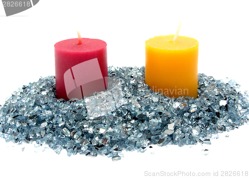 Image of Red and yellow candles on blue glitter