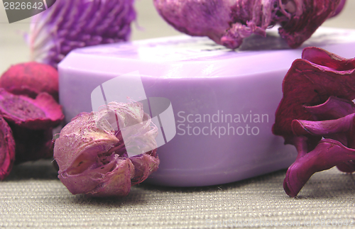 Image of Lilac soap with decoration articles on a  gray  background