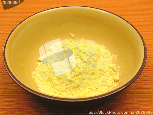 Image of Cornmeal  in a bowl of ceramic on an orange background