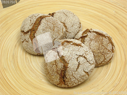 Image of Home made wholemeal vinschgauer buns on wooden underlay