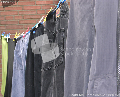 Image of Clothesline outside the house with some laundered clothes 