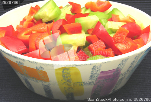 Image of Slices of cucumber and red pepper in a ceramics bowl