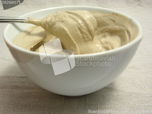 Image of Quark cheese mixed as dip in a bowl of chinaware on a placemat