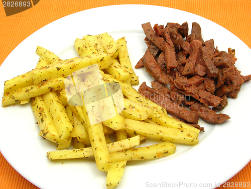 Image of Soy Geschnetzeltes and french fries on white plate
